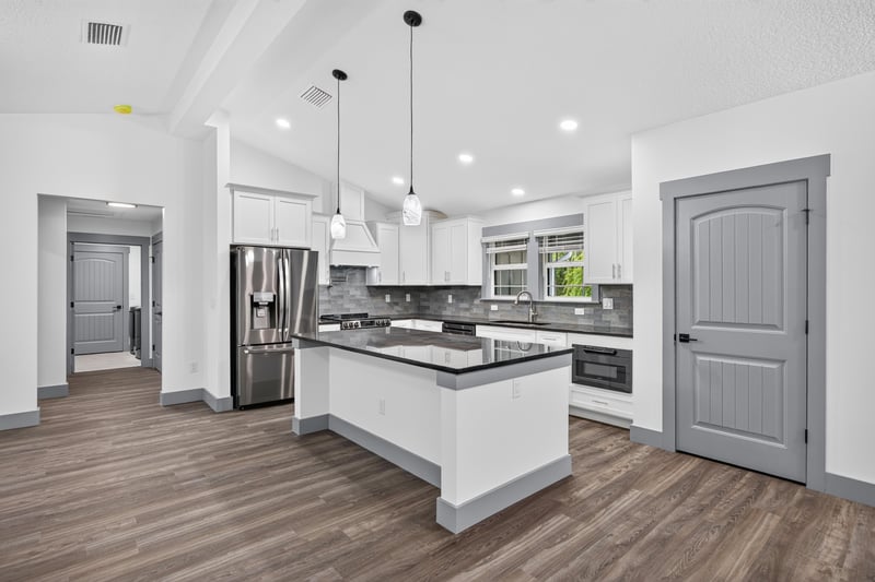 Kitchen with white cabinets and stainless refrigerator at 4800 Acacia St, Middleburg, FL 32068