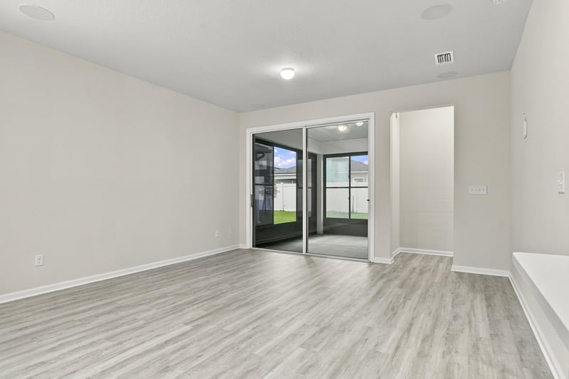 Living room with sliding glass doors to the backyard at 7088 Mahogany Run Dr, Jacksonville, FL 32244