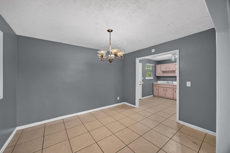 Dining area staged with view toward kitchen at 6745 Jack Horner Ln, Jacksonville, FL 32210