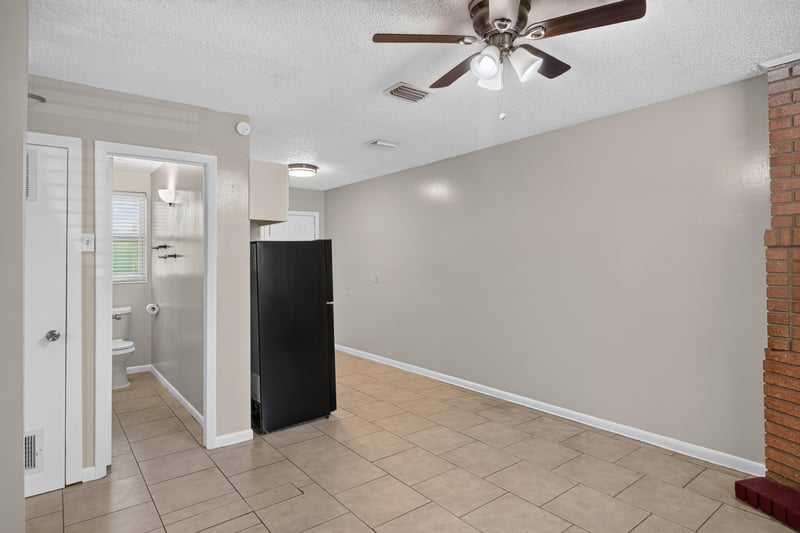 Hallway with tile floor leading to kitchen and bath at 8067 Parental Cir, Jacksonville, FL 32216
