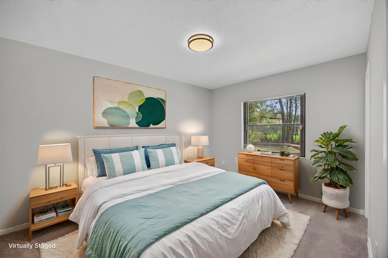 Virtually staged bedroom with bed, dresser and window view at 7453 Jade Dr N, Jacksonville, FL 32210