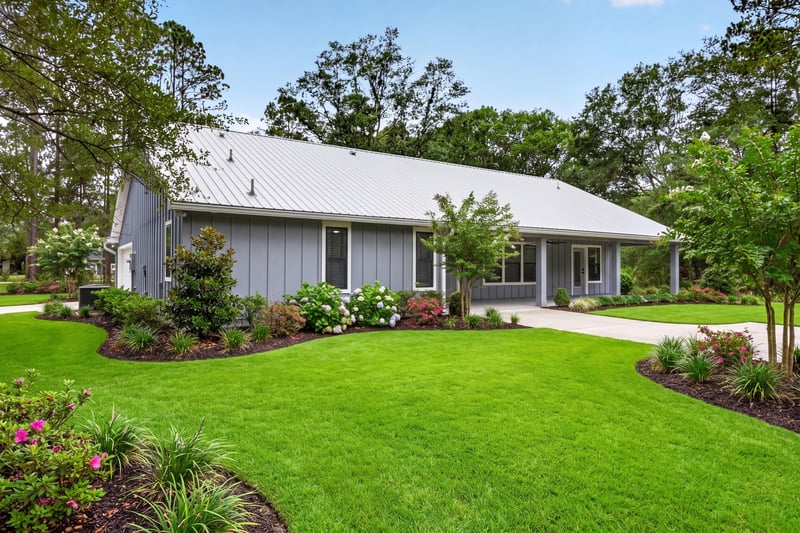 Side exterior with landscaped beds at 4800 Acacia St, Middleburg, FL 32068