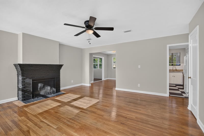 Living room with fireplace and ceiling fan at 6338 Mercer Cir W, Jacksonville, FL