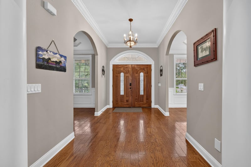 Front foyer with wood door and crown molding at 1735 Hagans Ridge Ct