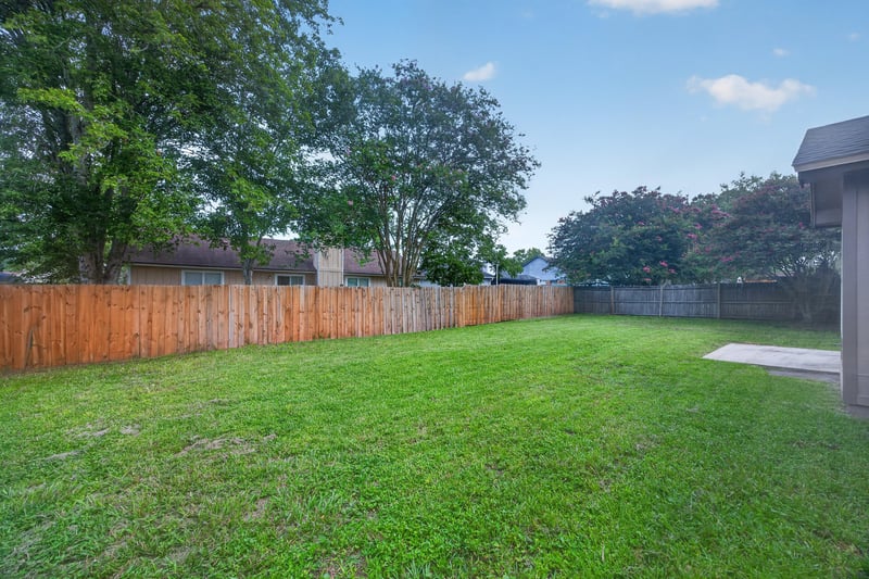 Backyard with grass lawn and wood fence at 6646 Shiloh Creek Dr