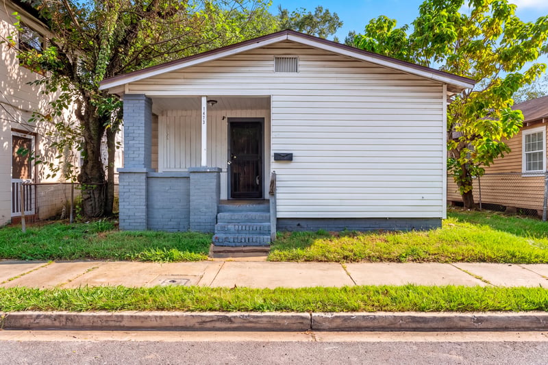 Front exterior with covered porch and blue painted steps at 1473 State St W, Jacksonville, FL 32209