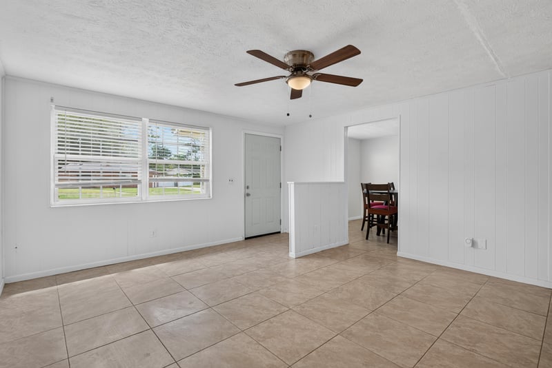 Living room with windows and ceiling fan at 9954 Larkdale Ct, Jacksonville, FL 32257