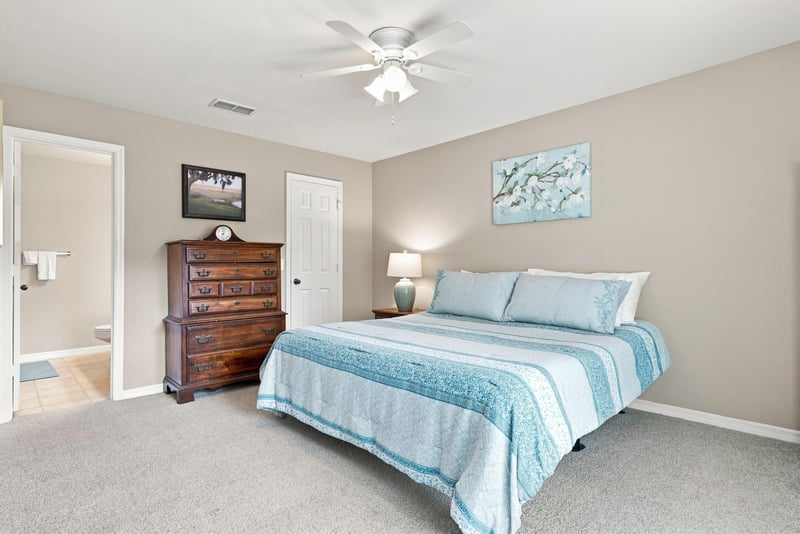 Bedroom with bed and wood dresser at 7800 Point Meadows Dr, Jacksonville, FL 32256