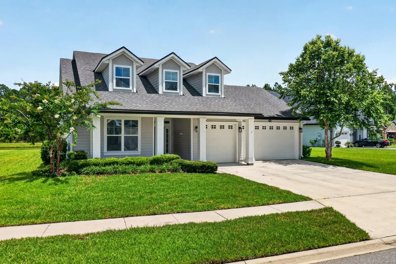 Front exterior close view of entry and three-car garage at 53 Lumen Ct, St. Augustine, FL 32095