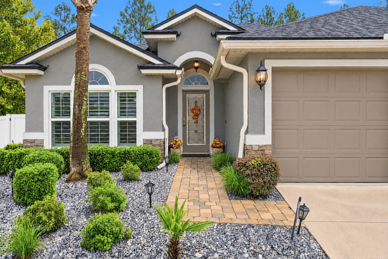 Front entry with stone walkway and shrubs at 10923 Black Diamond Ct, Jacksonville, FL