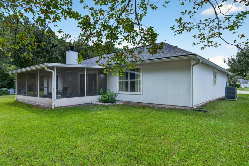 Backyard with screened porch and chimney at 13514 Las Brisas Way N, Jacksonville, FL