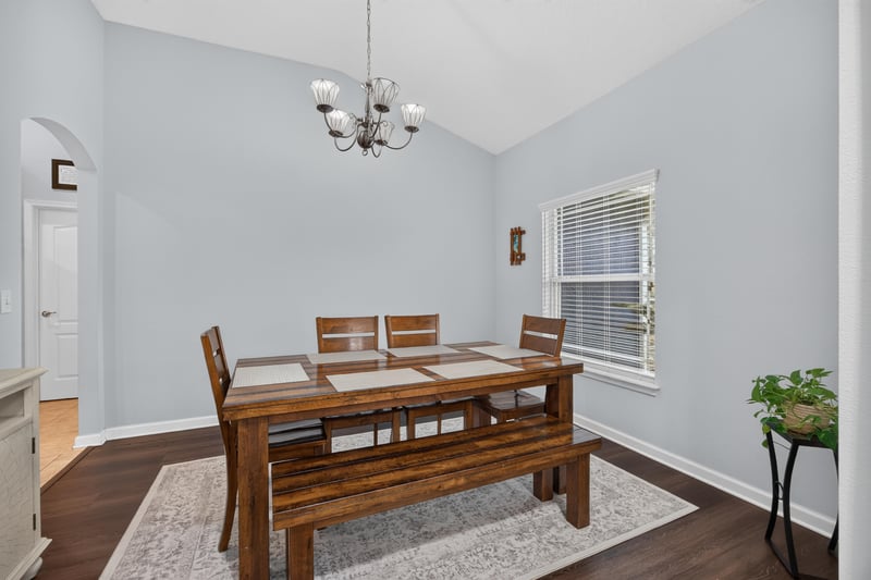 Dining room with wood table and chandelier at 538 Porta Rosa Circle, St. Augustine, FL 32092