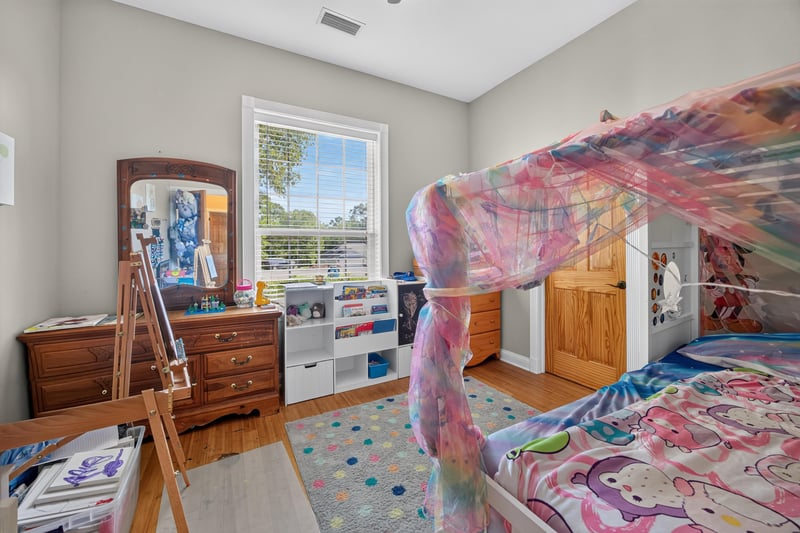 Bedroom with canopy bed and dresser at 1735 Hagans Ridge Ct