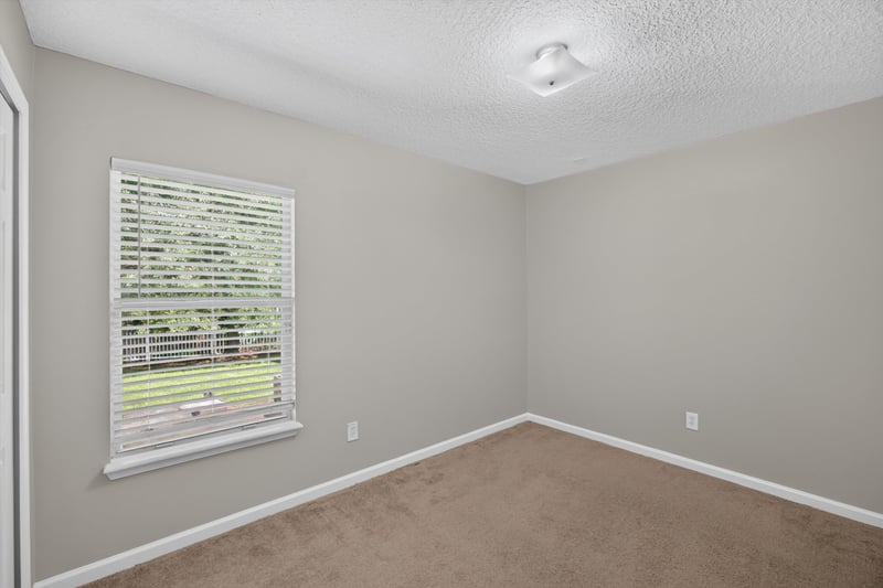 Carpeted bedroom with window at 14147 Fish Eagle Dr E, Jacksonville, FL 32226