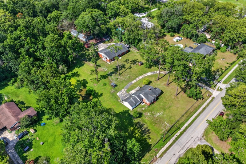 Aerial view of the home among trees and street at 5745 110th St, Jacksonville, FL 32244