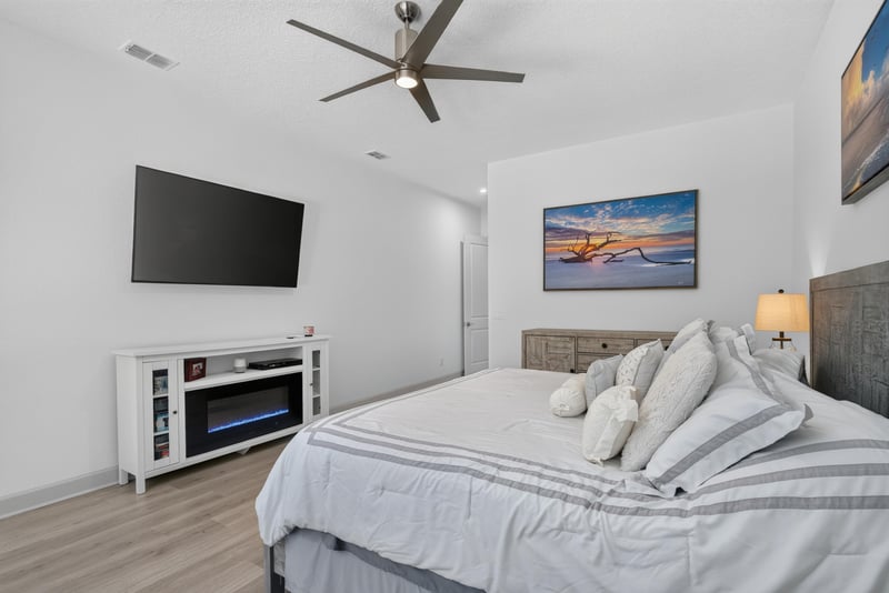 Bedroom with wall-mounted TV and ceiling fan at 785 Back Creek Dr, St. Augustine, FL 32092