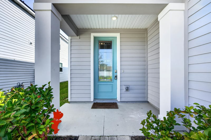 Covered front entry with teal door at 331 Millerstone Dr, St. Augustine, FL 32092