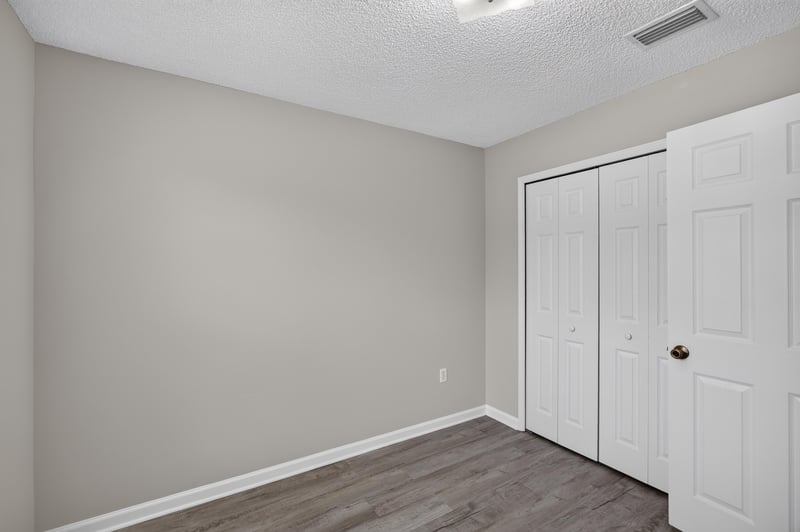 Bedroom with closet doors at 8519 Blazing Star Ct, Jacksonville, FL 32210