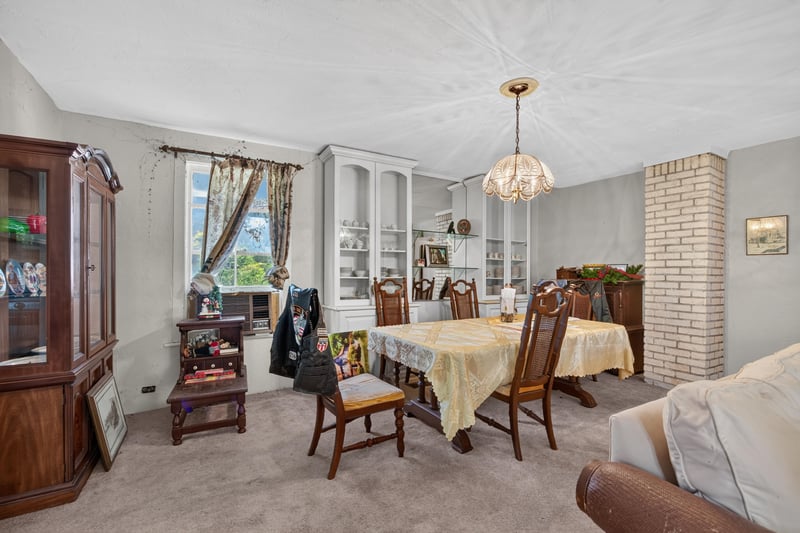 Dining area with glass-front china cabinet at 1173 US-17, Satsuma, FL 32189