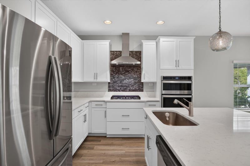 Kitchen with stainless appliances and tile backsplash at 75875 Saffron Ln, Yulee, FL 32097