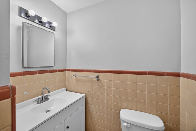 Bathroom vanity with peach tile wainscoting at 5527 Beney Rd, Jacksonville, FL 32207