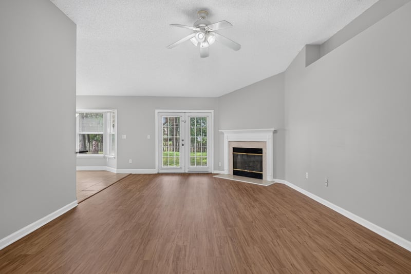 Living room with fireplace and French doors at 12949 Chets Creek Dr S, Jacksonville, FL 32224