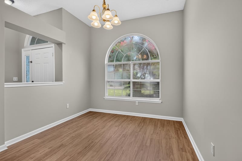 Empty room with arched window and columns at 12949 Chets Creek Dr S, Jacksonville, FL 32224