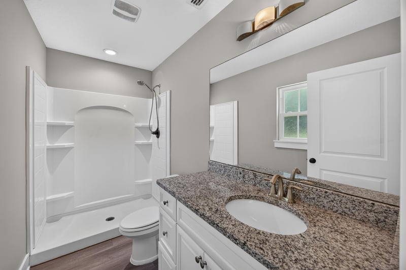 Bathroom with tub-shower and window at 2855 N 8th St, St. Augustine, FL 32084