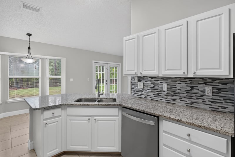 Kitchen with pendant light and cabinets at 12949 Chets Creek Dr S, Jacksonville, FL 32224