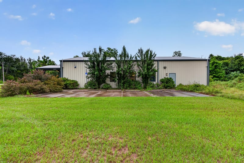 Exterior view of the second building and gravel lot at 1038 County Rd 315, Melrose