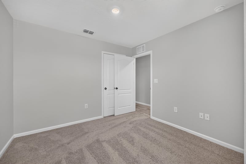 Empty room with closet doors at 2837 Black Buck Cir, Jacksonville, FL 32225