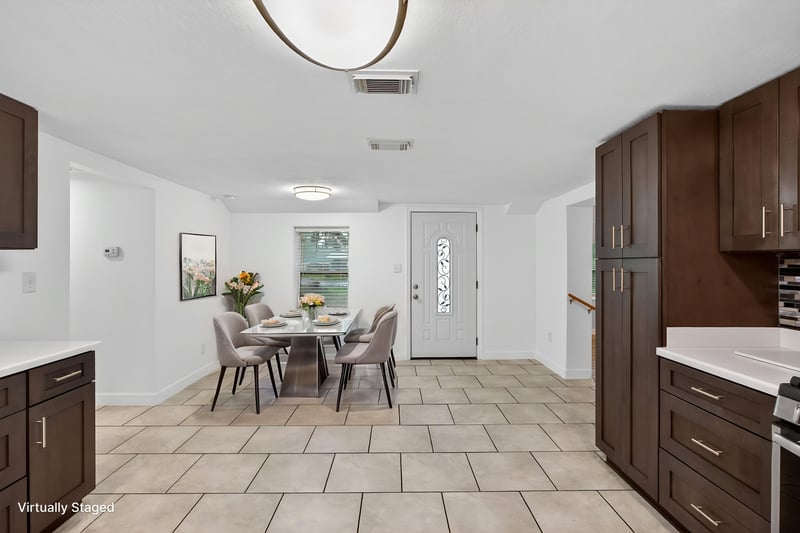 Dining area with staged table set on tile floor at 1619 Hammond Blvd, Jacksonville, FL