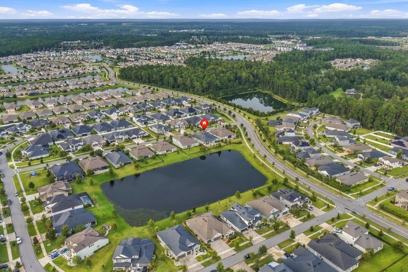 Overhead aerial showing the home's lot relative to nearby ponds and streets in Middleburg, FL