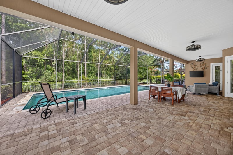 Covered patio with pool and lounge chairs at 276 Cross Ridge Dr, Ponte Vedra Beach, FL 32081