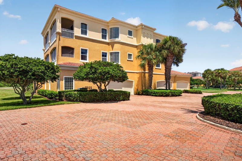 Front exterior with tile roof and circular paver driveway at 140 Ave De La Mer, Palm Coast, FL 32137
