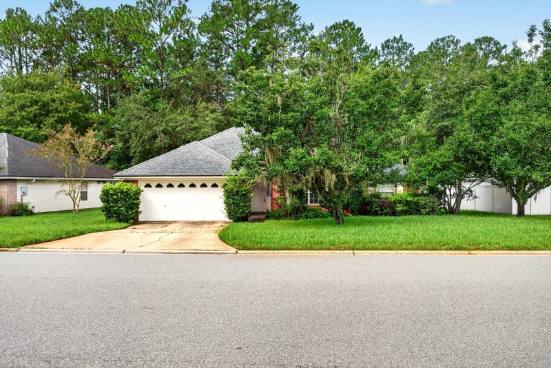 Front exterior with brick facade and driveway at 11669 Collins Creek Dr, Jacksonville, FL 32258