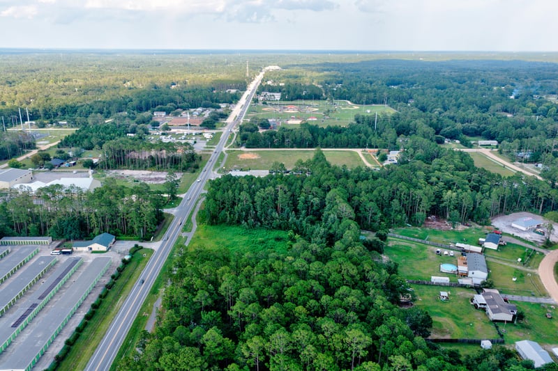 Wide aerial of the area with storage buildings and open road at 4393 Co Rd 218, Middleburg, FL 32068