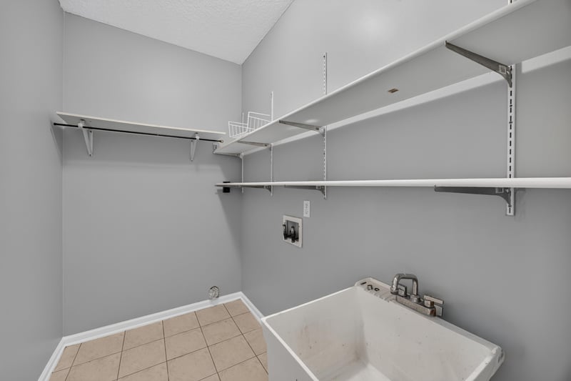 Closet with shelving and laundry utility sink at 470 Sparrow Branch Cir, Jacksonville, FL 32259