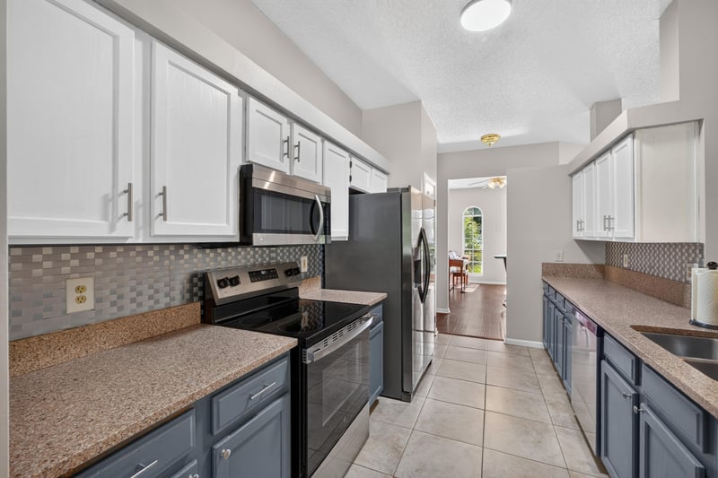 Kitchen with stainless appliances and tile backsplash at 11828 Heather Grove Ln, Jacksonville, FL