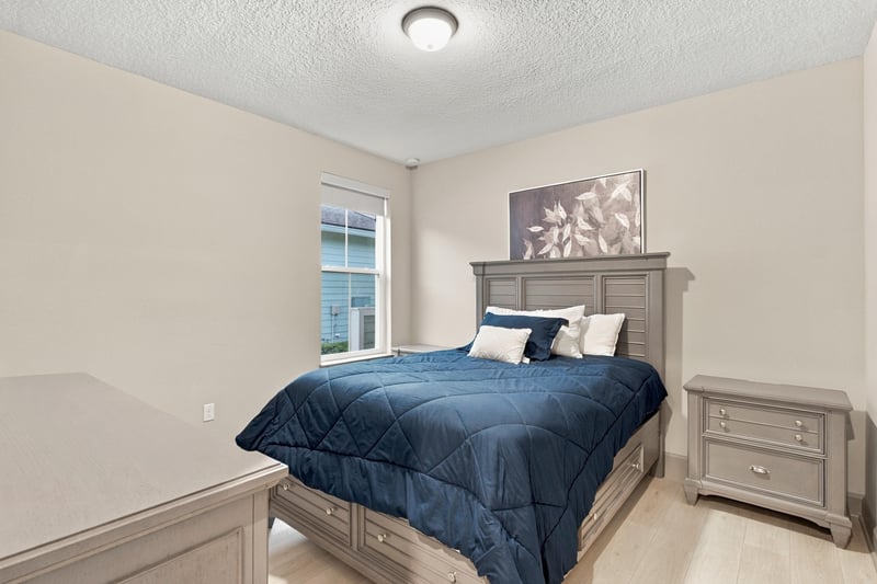Bedroom with upholstered headboard and nightstand at 3921 Spyglass Hill Ln