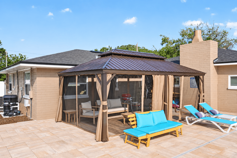 Backyard pool area with gazebo and grill at 1525 8th St N, Jacksonville Beach, FL