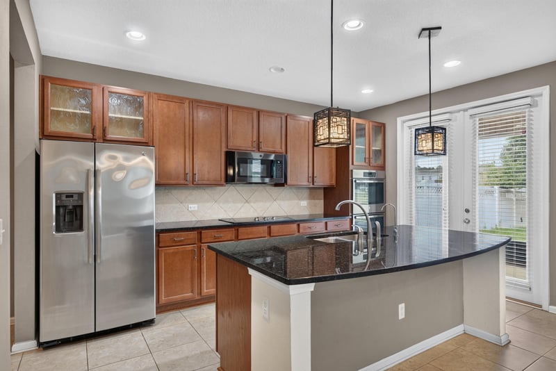 Kitchen island with granite counters and stainless appliances at 263 Gilmore Ln, Orange Park, FL 32065