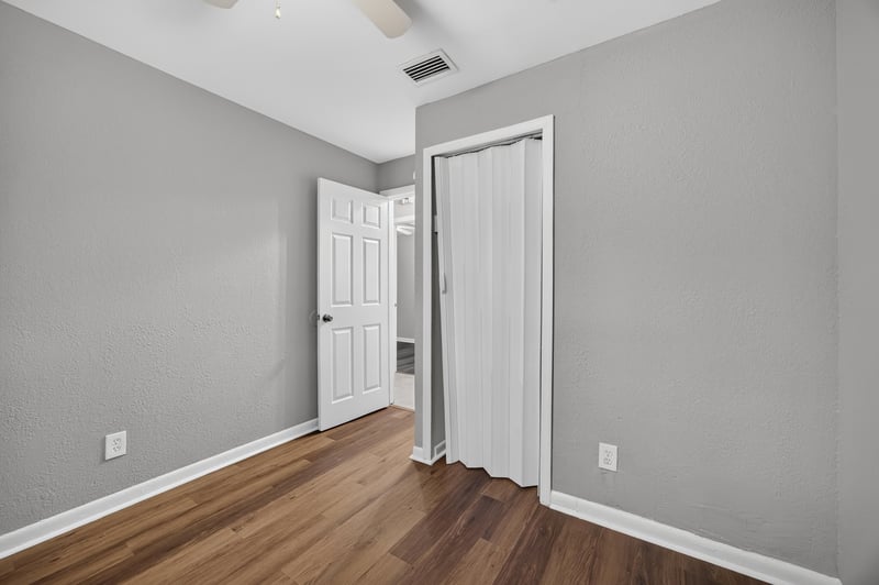Empty room with doorway and wood-look floor at 4030 Leonard Cir W, Jacksonville, FL 32209