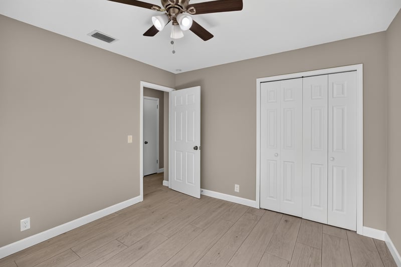 Empty bedroom with closet and wood-look flooring at 4117 Wilcrest Ct, Jacksonville, FL 32277