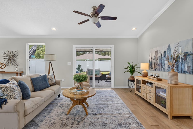 Living room with sliding glass doors to the patio at 10066 Andean Fox Dr, Jacksonville, FL 32222