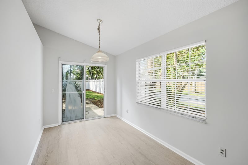 Dining nook with sliding glass door at 678 5th Ave N, Jacksonville Beach, FL 32250