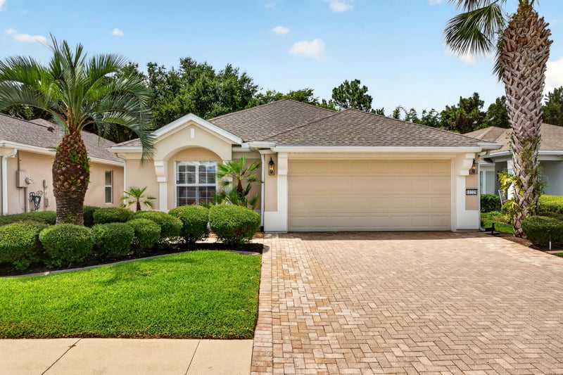 Front exterior showing garage doors and lawn at 11225 Water Spring Cir, Jacksonville, FL 32256