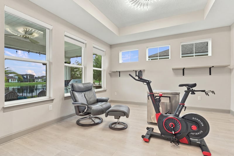 Sunlit flex room with windows and exercise equipment at 3921 Spyglass Hill Ln