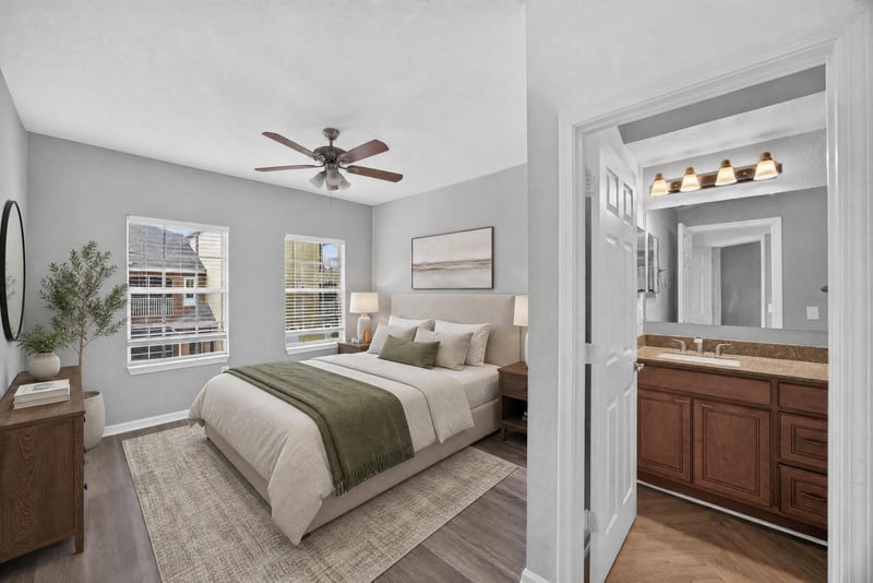 Virtually staged bedroom with bed and ceiling fan at 10075 Gate Pkwy unit 1905, Jacksonville, FL 32246