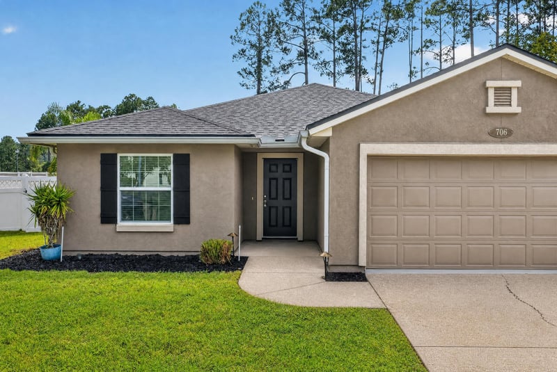 Front exterior entry and garage at 706 Grampian Highlands Dr, St. Johns, FL 32259